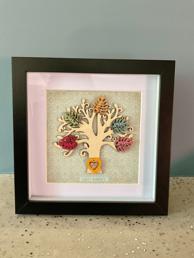 Wooden tree frame with colourful wooden leaves. Sweet moments quote.