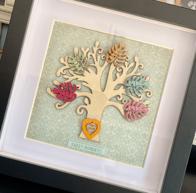 Wooden tree frame with colourful wooden leaves. Sweet moments quote.