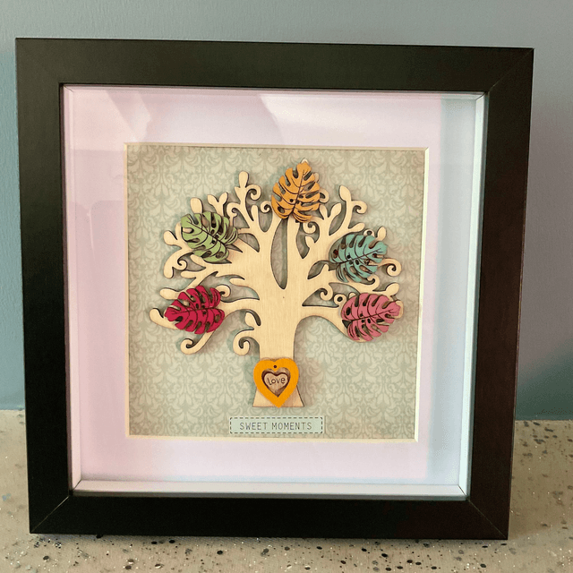 Wooden tree frame with colourful wooden leaves. Sweet moments quote.