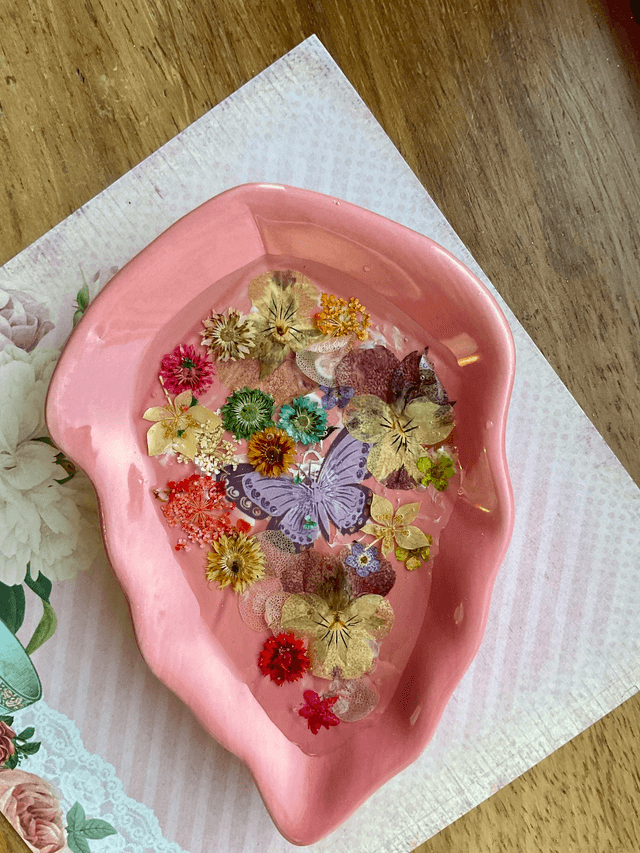 Pink leaf ring trinket tray with pressed flowers.