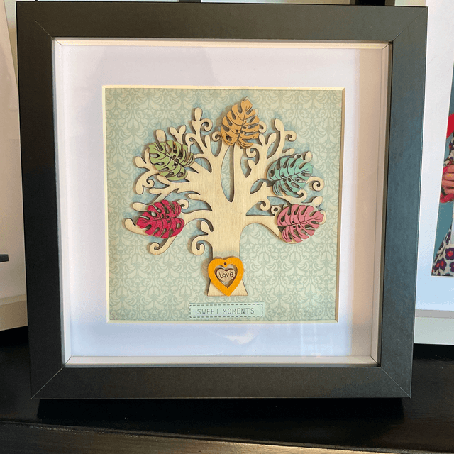 Wooden tree frame with colourful wooden leaves. Sweet moments quote.