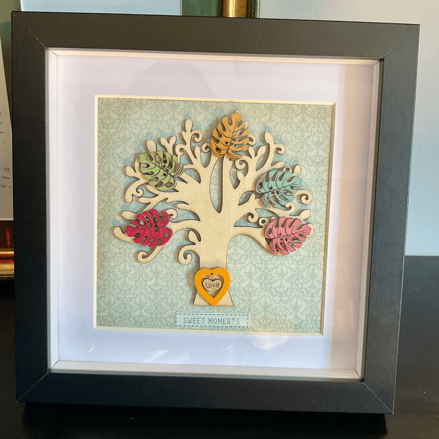 Wooden tree frame with colourful wooden leaves. Sweet moments quote.
