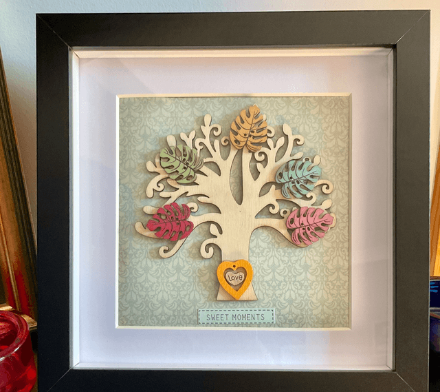Wooden tree frame with colourful wooden leaves. Sweet moments quote.