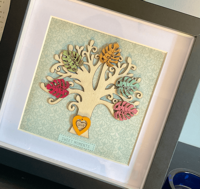 Wooden tree frame with colourful wooden leaves. Sweet moments quote.